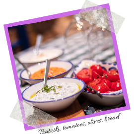 Text reads: Tzatziki, tomatoes, olives, bread