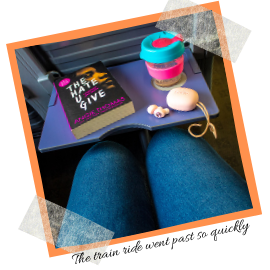 Picture of my jeans, a book, headphones and a keep cup all positioned on a train. Caption reads: The train ride went past so quickly