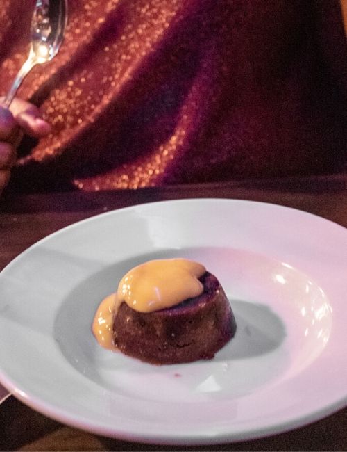 Photo of the Christmas pudding on a plate with custart from Sage & Chilli