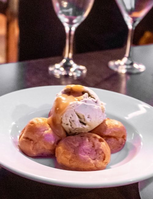 A photo of the profiteroles with pistachio ice cream from Sage & Chilli