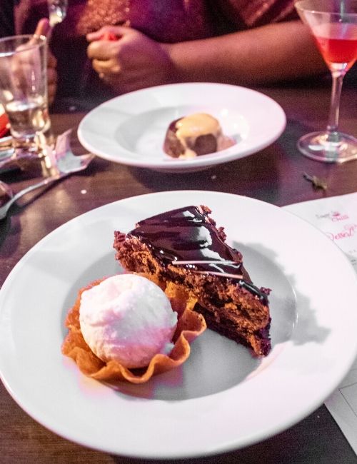 A photo of the chocolate torte, paired with vanilla ice cream in a brandy biscuit basket.
