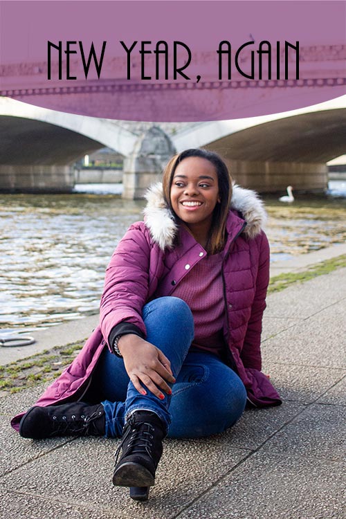 Photo of author Jasmine Burke in a purple coat. The words 'New Year Again' have been edited onto the photo.