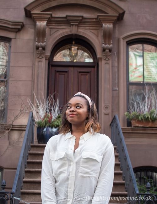 Me smiling outside of the Sex and the City apartments.
