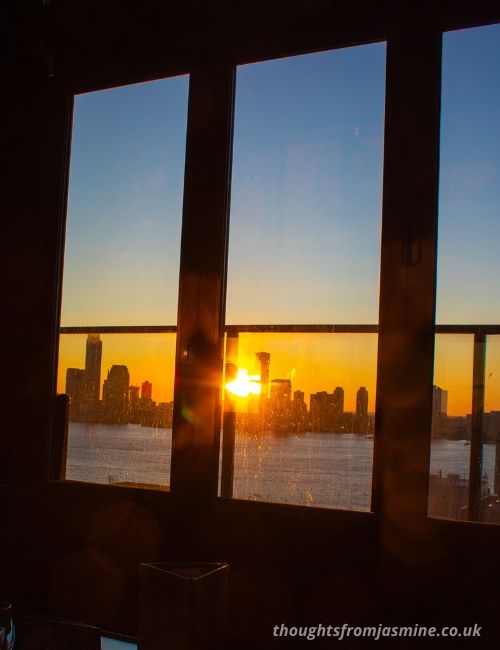 Picture of the New York sunset through a window.