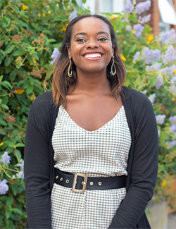 Photo for new chapter post. Author Jasmine Burke is wearing earrings and smiling