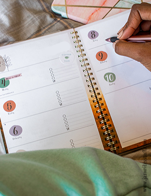 A photo of someone writing in a diary