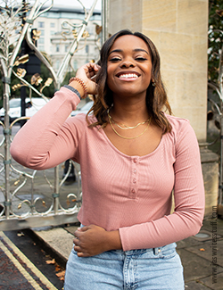 picture of author in a pink ribbed long sleeved top, that she believes is a perfect piece of transitional clothing for autumn