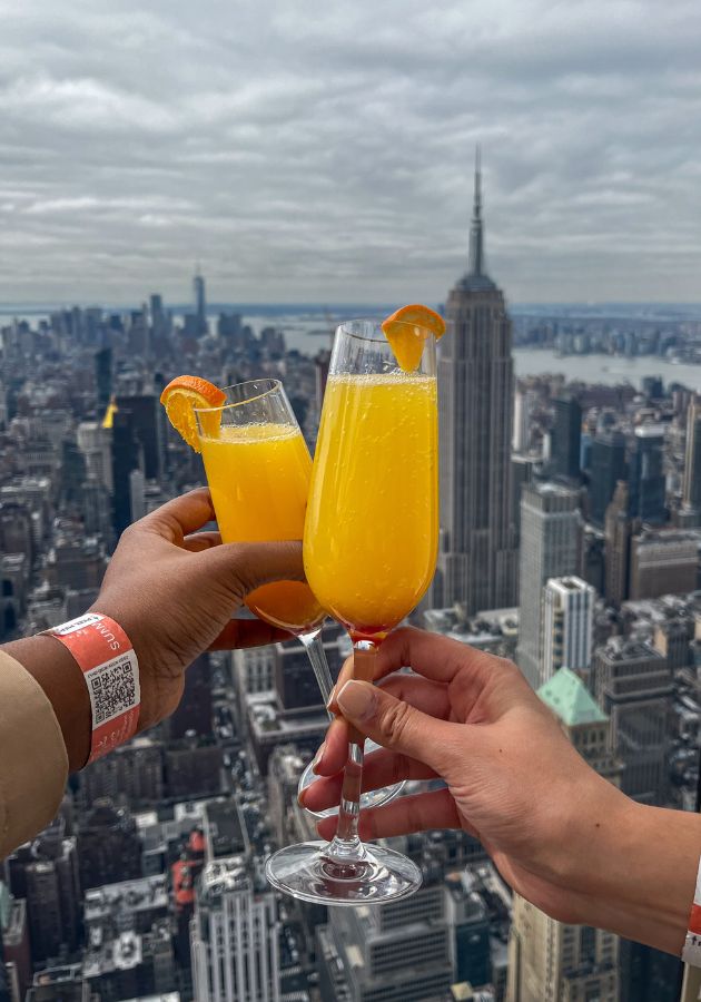 A photo of two friends cheersing mimosas