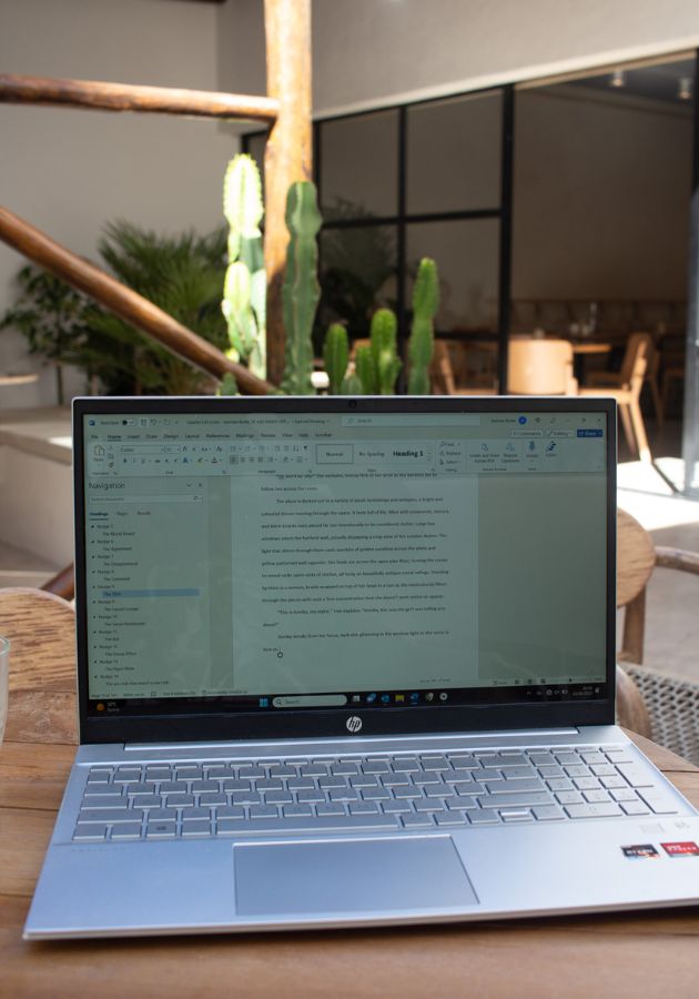 Photo of laptop in sunlit cafe