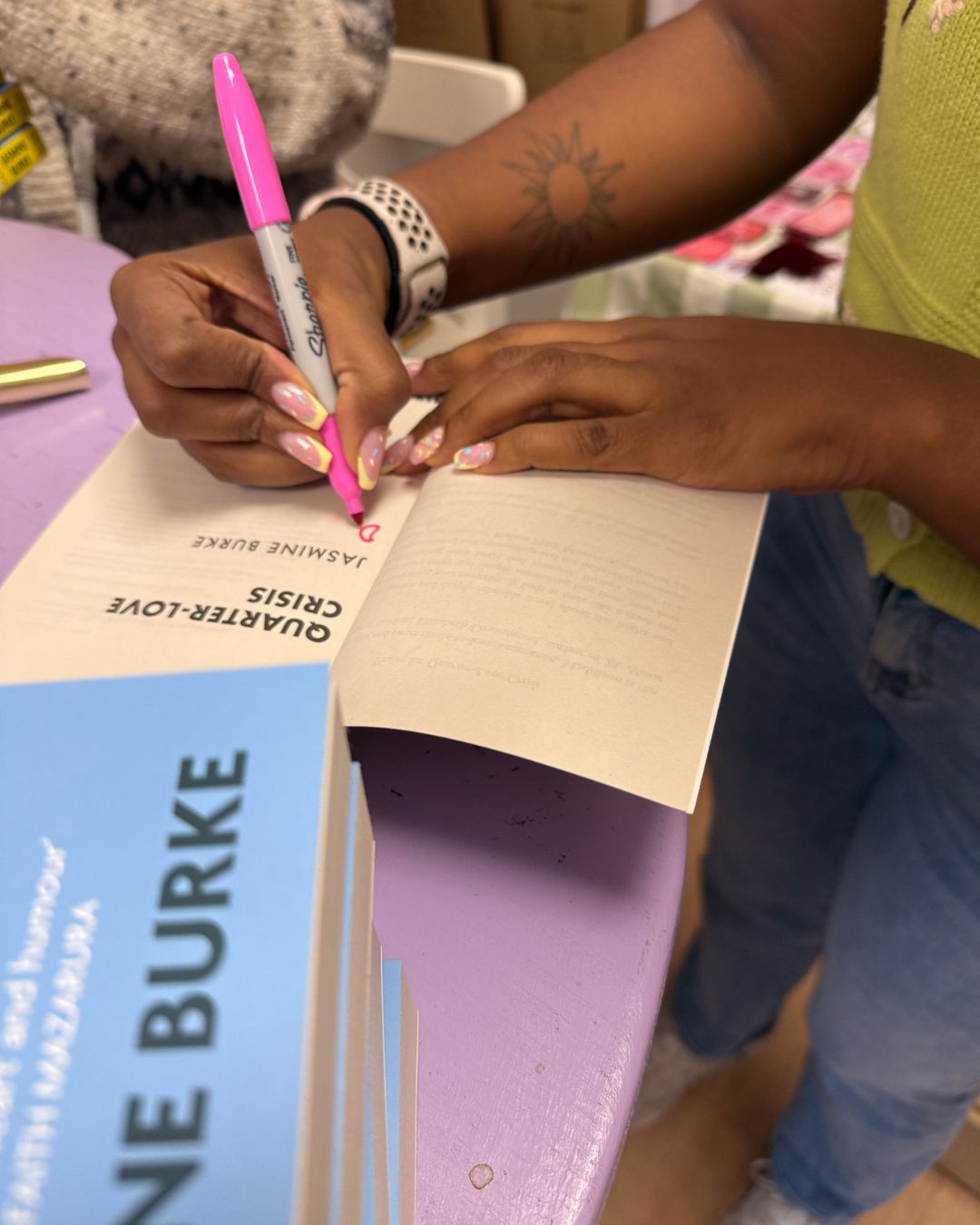 A close-up photo of me signing my novel, Quarter-Love Crisis