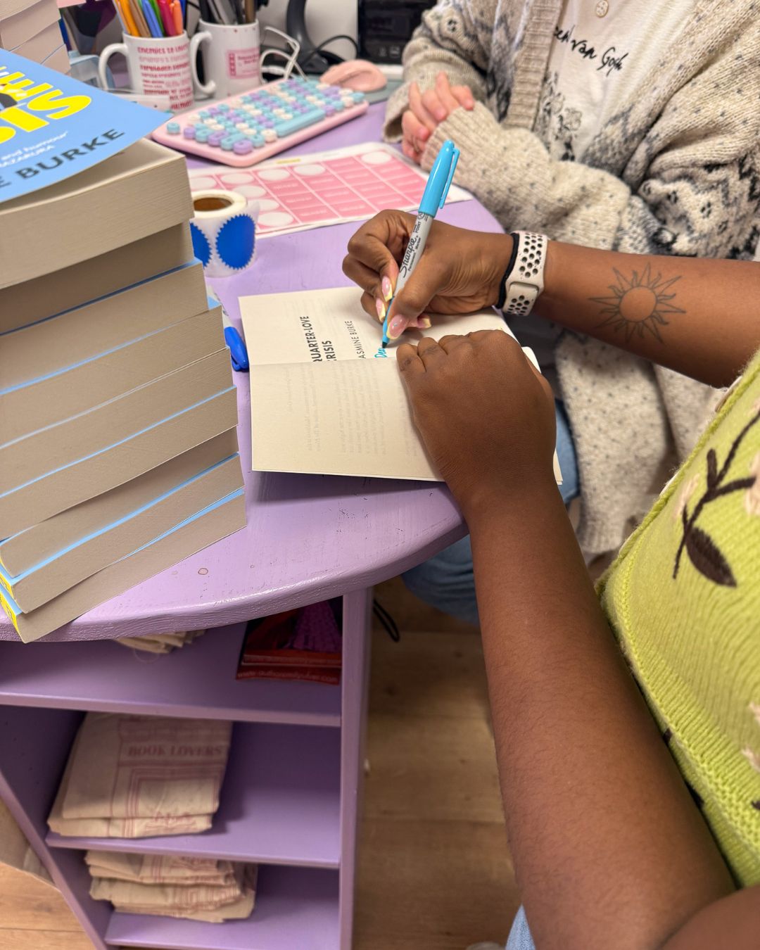 A close-up photo of me signing my novel, Quarter-Love Crisis